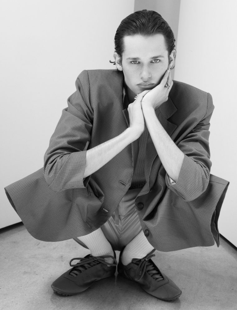 Charlie Nolte shot by Beau nelson squatting in a grey suit male model